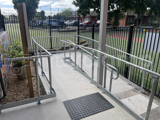 Interclamp DDA Assist key clamp handrail installed on an access ramp to a primary school.  